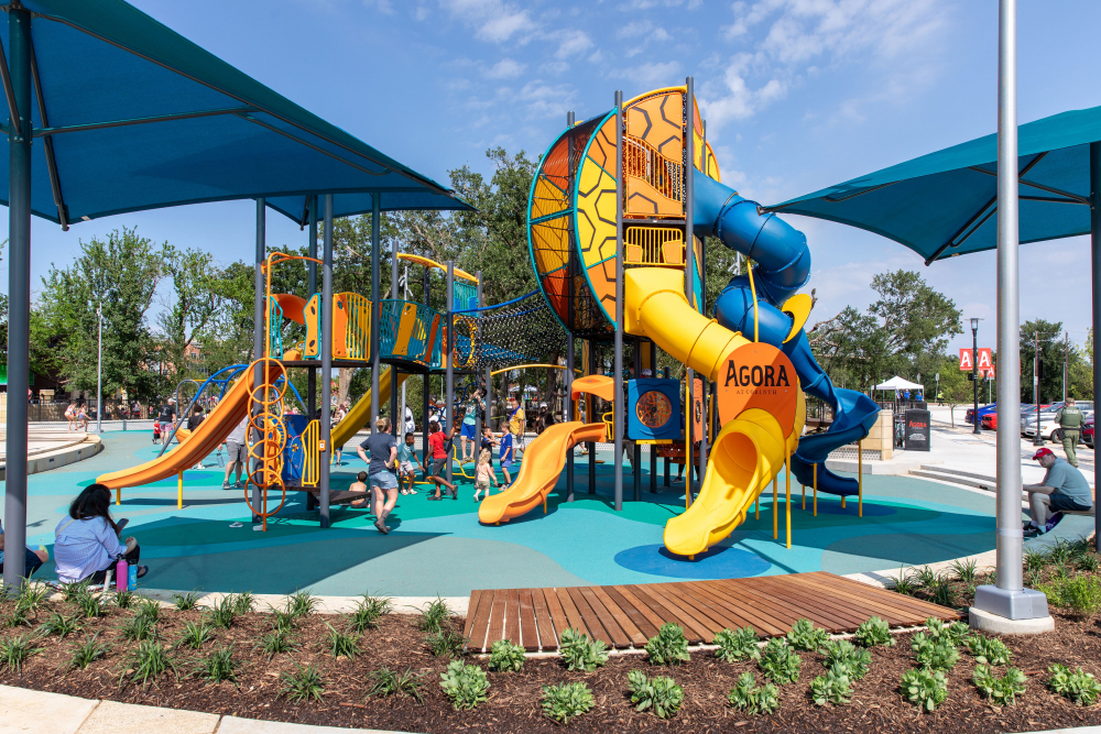 Children playing at the Commons at Agora splash pad in Corinth, TX